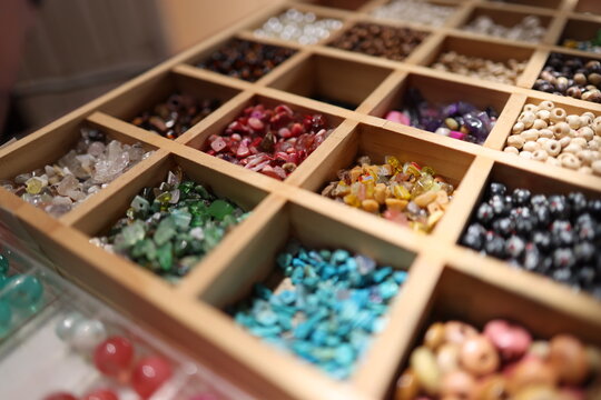 Assorted Colorful Jewelry Beads and Gemstones in Wooden Organizer Box