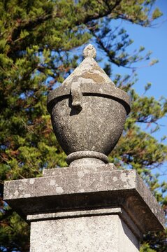 Stone urn sculpture decorating a garden pillar. Portugal - Norte