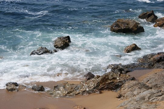 Ocean waves crashing on rocky beach coastline. Portugal - Norte