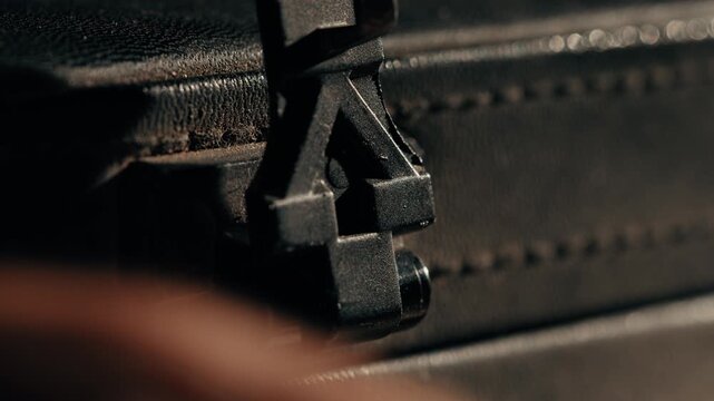 The clasp of a black briefcase that snaps open macro shot