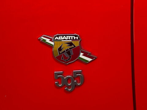 Abarth 595 emblem and lettering on the red body, symbolizing Italian sportscar design and engine performance