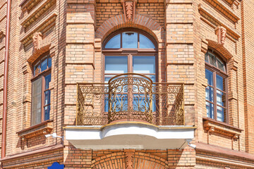 Obraz premium Wrought iron balcony on brick facade of historic Kozina House in Minsk, Belarus