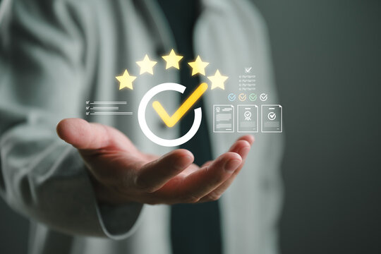 Customer satisfaction and quality assurance concept, five star rating, approval checkmark and certification icons above a business hand, service excellence, compliance, trust and customer experience.