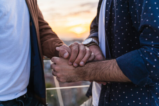 Close-up of gay couple holding hands