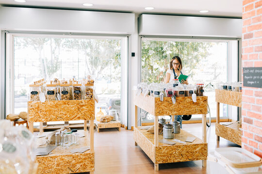 Entrepreneur organizing inventory in a zero waste grocery store