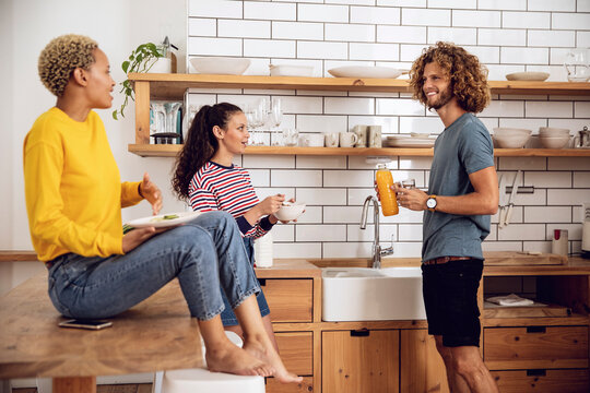 Friends having breakfast in the kitchen at home