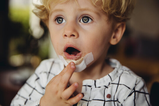 Portrait of little boy with patch on his chin