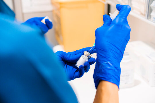 Hands of nurse preparing syringe at medical clinic