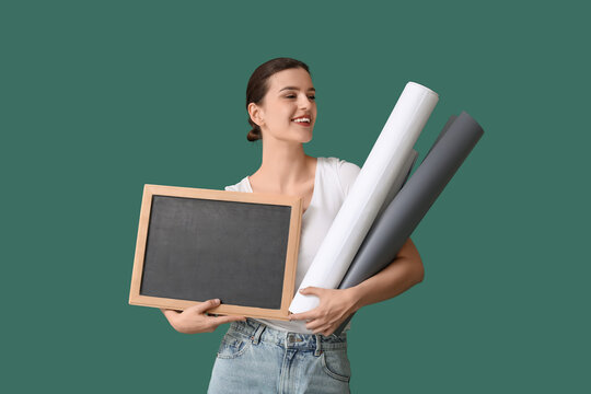 Female teacher with chalkboard and paper rolls on green background