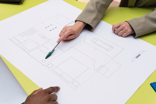 Architect explaining floor plan on table