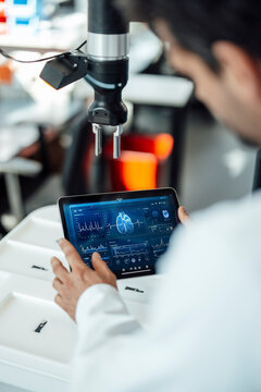 Researcher analyzing medical data on tablet in laboratory