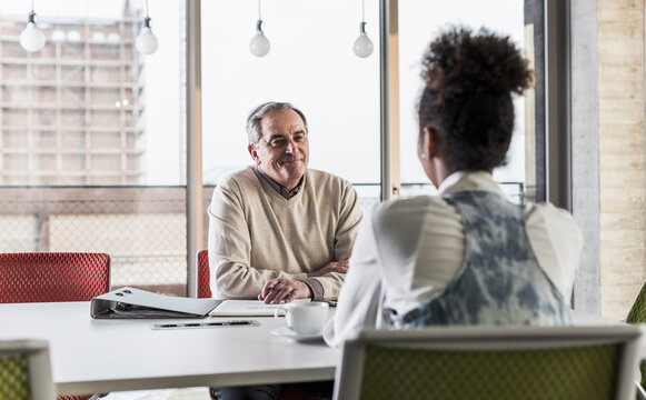 Businessman and young woman in conference room
