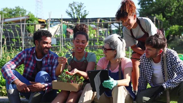 Senior farmer teaching young volunteers organic gardening