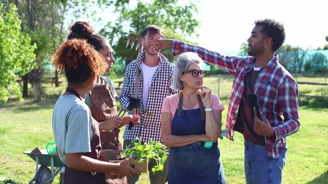 Diverse group of farmers attending gardening class outdoors