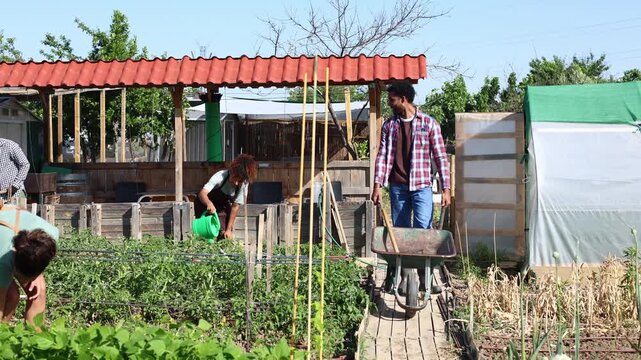 Multiethnic farmers working together in a community garden