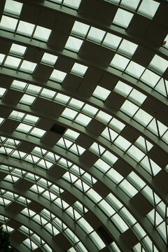 Glass roof against the blue sky that design to opaque and translucent .Modern glass silhouettes of skyscrapers. Business building.