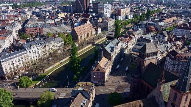 Saint Peter the Old Protestant Church overlooks the Faux Rempart Canal in the UNESCO-listed Grande &Icirc;le of Strasbourg, Bas-Rhin, Grand Est, France, drone forward flight reveal.