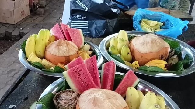 Arranging Slices of Red Watermelon on a Silver Tray to Prepare a Traditional Sri Lankan Palathuru Wattiya Offering for Kataragama Deity