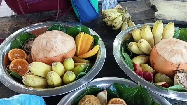 Placing Fresh Sliced Mango on a Silver Platter to Prepare a Traditional Sri Lankan Palathuru Wattiya Deity Offering at Kataragama