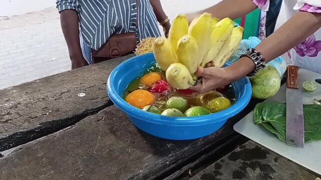 Washing Sour Bananas Ambul Kesel in Holy Turmeric and Lime Water for Spiritual Purification of Sri Lankan Temple Palathuru Wattiya