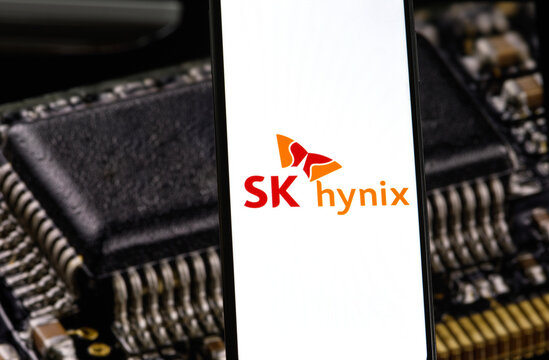 The SK hynix logo is displayed on a mobile phone, with computer memory chips in the background. SK hynix is a South Korean technology company specializing in semiconductor memory and chipsets.