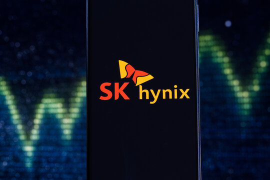 The SK hynix logo is displayed on a mobile phone, with stock chart in the background. SK hynix is a South Korean technology company specializing in semiconductor memory and chipset technology, Warsaw,