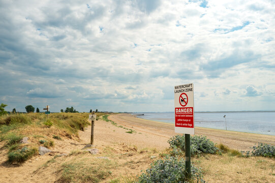 Danger area and No Swimming sign seen on the English coast near Hunstanton and Heacham, looking out to The Wash. Marine vessels launch from the area which may pose a risk for swimmers.