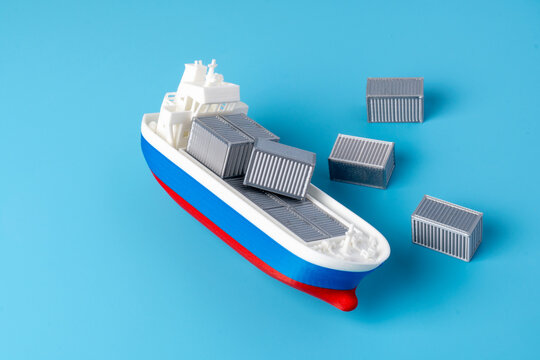 Miniature cargo ship capsizing on a blue background with freight containers falling off. Maritime insurance claims, shipping accidents, lost cargo concept.