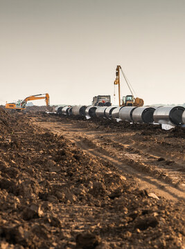 Large Steel Pipeline Construction Across Rural Landscape