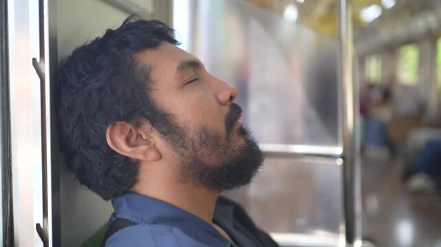 Tired Asian Commuter Resting During Train Journey in Indonesia