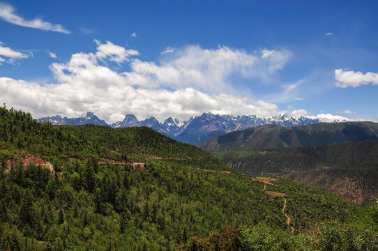 Beautiful mountain landscape with lush greenery and distant snow-capped peaks