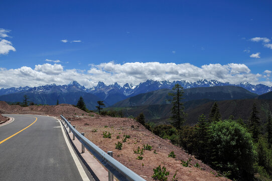 Scenic road with mountain range and clear blue sky in the background