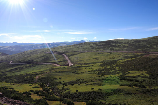 Scenic mountain landscape with winding road under clear sky