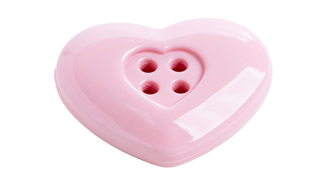 Glossy pink heart-shaped button with four holes, isolated on transparent background