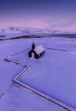 Budir church stands isolated in a pristine snow covered winter landscape on the Snaefellsnes Peninsula, Iceland
