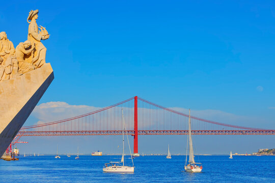 View of Monument to the Discoveries (Padrao dos Descobrimentos) and 25th April bridge in the distance, Belem, Lisbon, Portugal