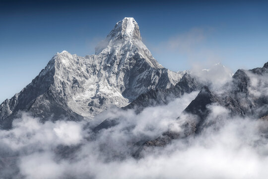 The iconic pyramid of Ama Dablam dominates the skyline above a sea of clouds, Khumbu region, Nepal.