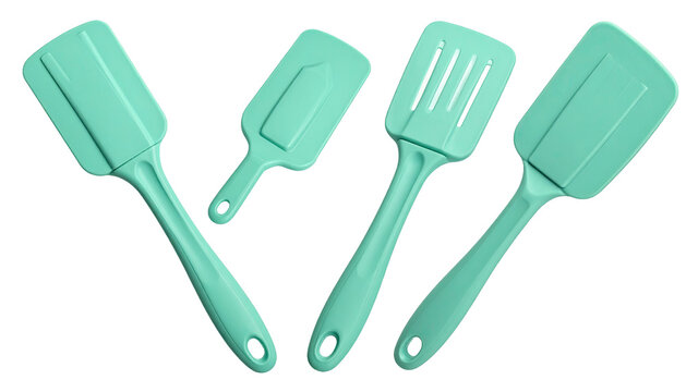 4 mint green plastic spatulas isolated on a white background, in different angles and positions.