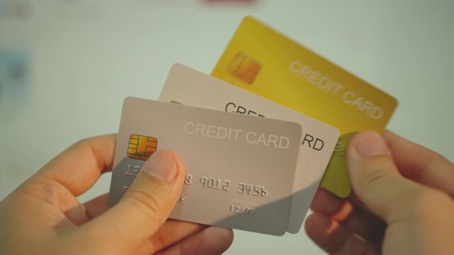 Hand Holding Multiple Credit Card shows chip and digits mock up with Online market screen background.