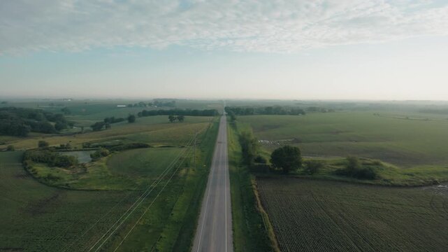 Wide aerial shot of a road running through rural Iowa.