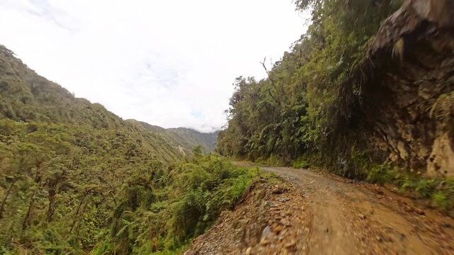 Driving Along Death Road Amid Lush Mountain Valley In Bolivia