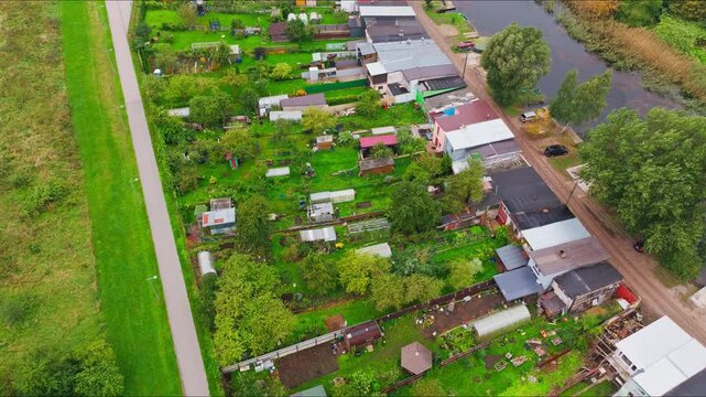 Drone flies forward, tilting down, Liepaja, Zirgu Island, allotments boathouses