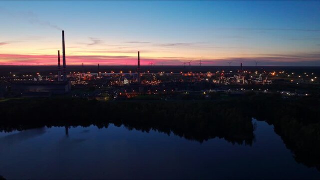 Drone slides right above Orlen Lietuva refinery at sunset, Juodeikiai Lithuania