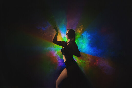  Portrait of fashion young girl dancing in red and blue neon light in the futuristic club.