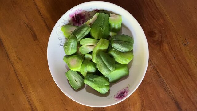 4K Top View Video of Steamed Chayote Sechium Edule Slices on Ceramic Plate for Healthy Cooking and Food Documentary Footage