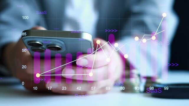 Data analysis with smartphone and graphs in office setting during daytime.