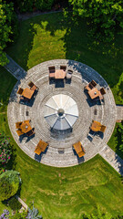 Fototapeta premium Aerial View of Outdoor Patio with Seating and Umbrella in Garden