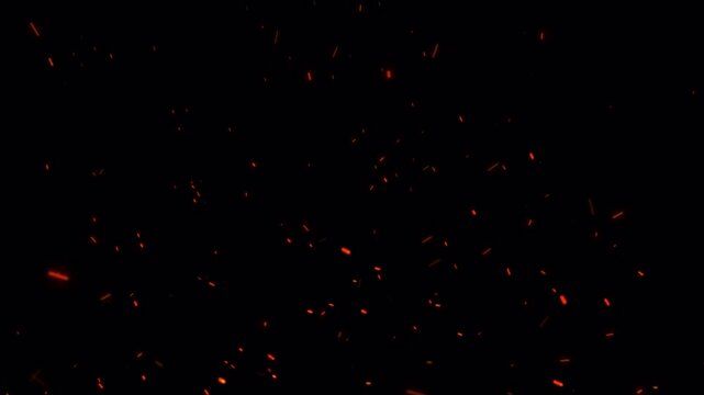 Realistic isolated fire sparks transparent background glowing embers particles floating in the air for visual effects and overlays.