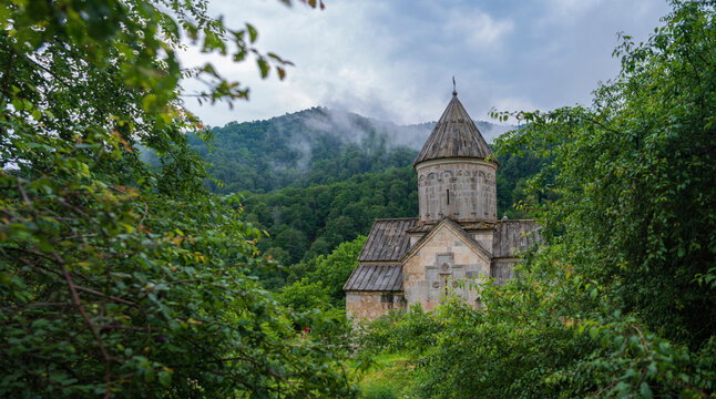  Haghartsin monastery stone church framed by green leaves with copy space