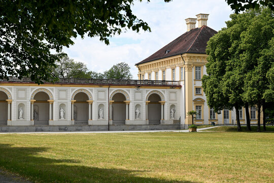 Classical palace colonnade with statues and trees